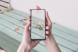 3D dinosaurs augmented reality projection on table with smart phone