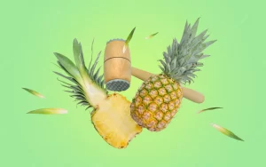 Kitchen hammer breaks the pineapple into pieces