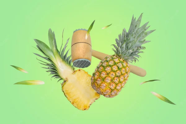 Kitchen hammer breaks the pineapple into pieces