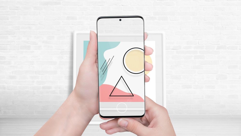 Watching an art exhibition of paintings through an augmented reality app concept